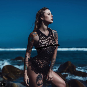 alysha nett, female model, woman on beach in front of coastline