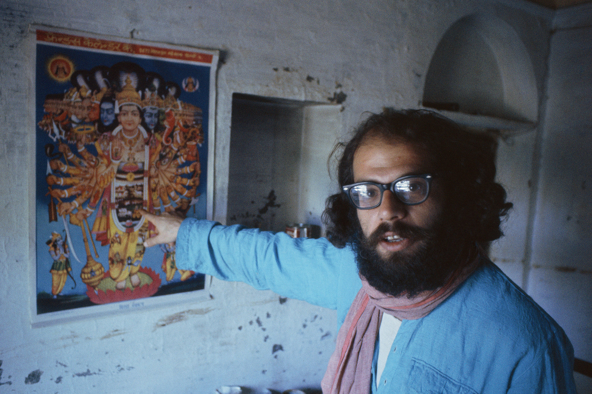 allen ginsberg kolkata BENARES, INDIA - FEBRUARY 1963: Beat poet Allen Ginsberg points at art poster during February 1963 in his tenement apartment near the banks of the Ganges river in Benaras, India. Ginsberg explored Eastern philosophies with Peter Orlovsky and other founders of the Beat movement during his March '62 - May '63 stay. (Photo by Pete turner/Getty Images)