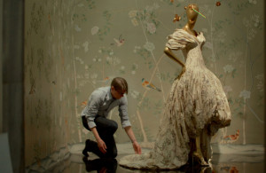 first monday in may, man working on a dress on a mannequin
