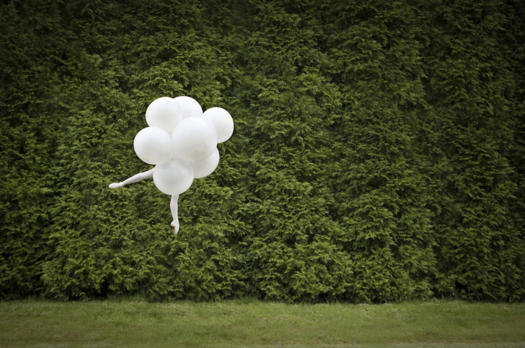 cade martin photography, white balloons against green hedges