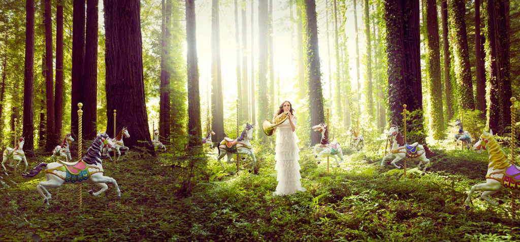 cade martin photography, model standing in the woods with carousel horses