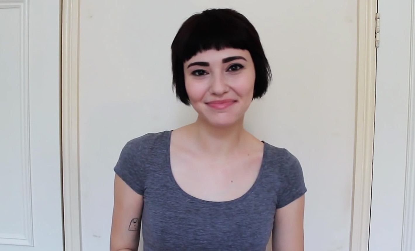 hi i am a slut, slam poetry, woman smiling with gray scoop neck shirt