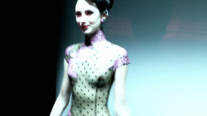 Atsuko Kudo's Lingerie London show, backstage shot of a model in latex corset with breasts exposed