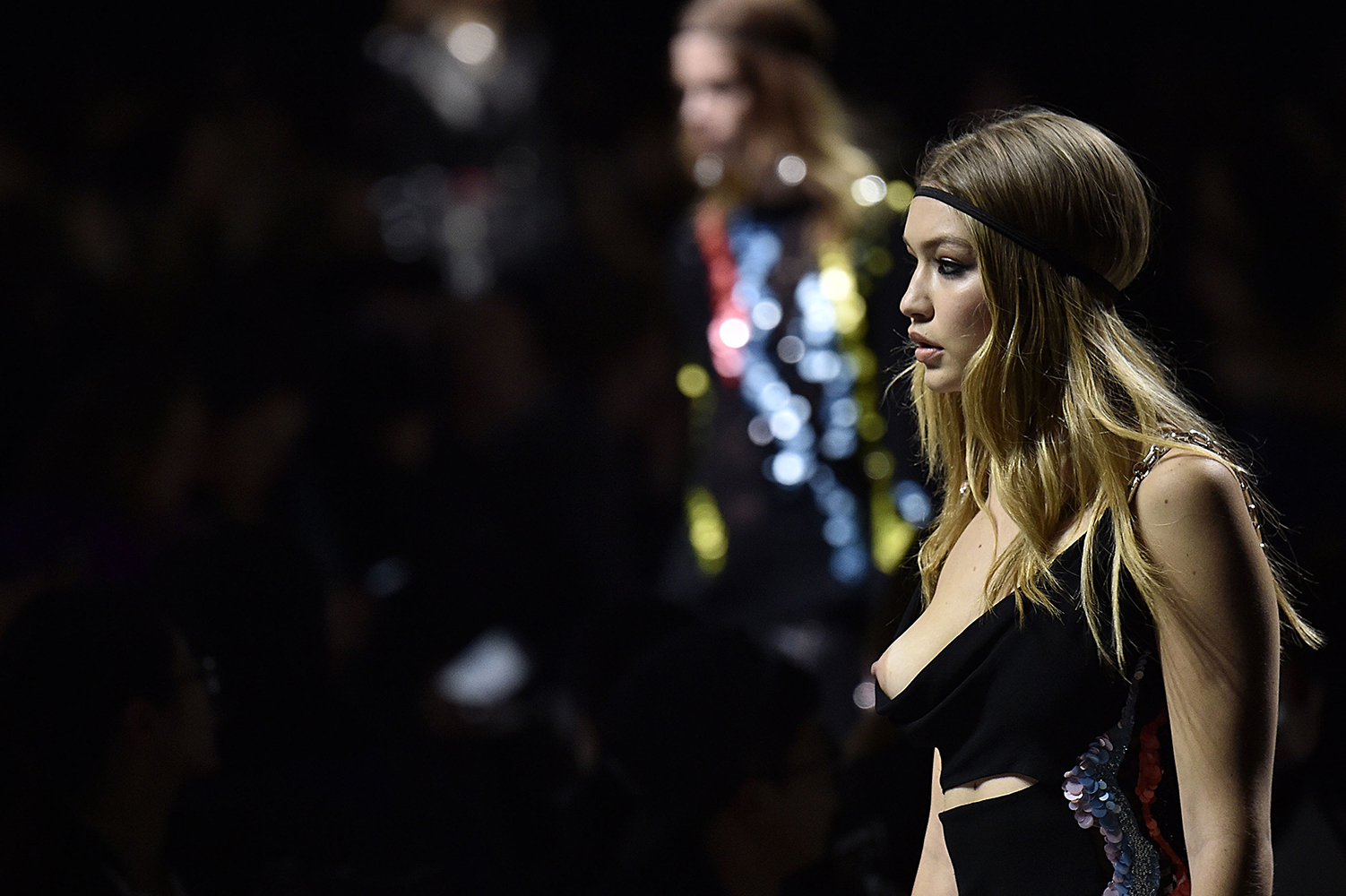 gigi hadid, fashion model on runway with breat exposed, pezon