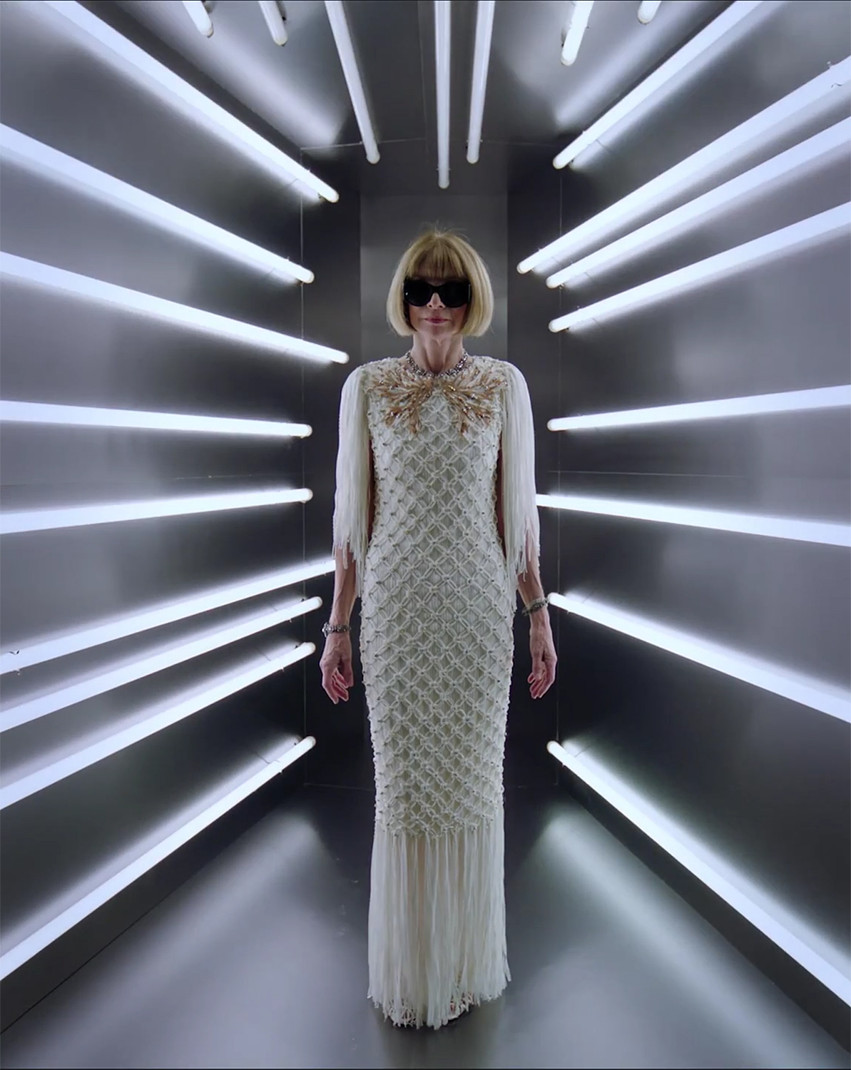 anna wintour in white dress surrounded by white lights