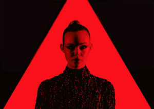 neon demon movie, elle fanning in red triangle and red light wearing a black dress