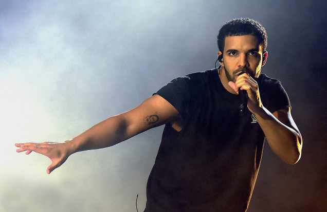 drake singing into a microphone
