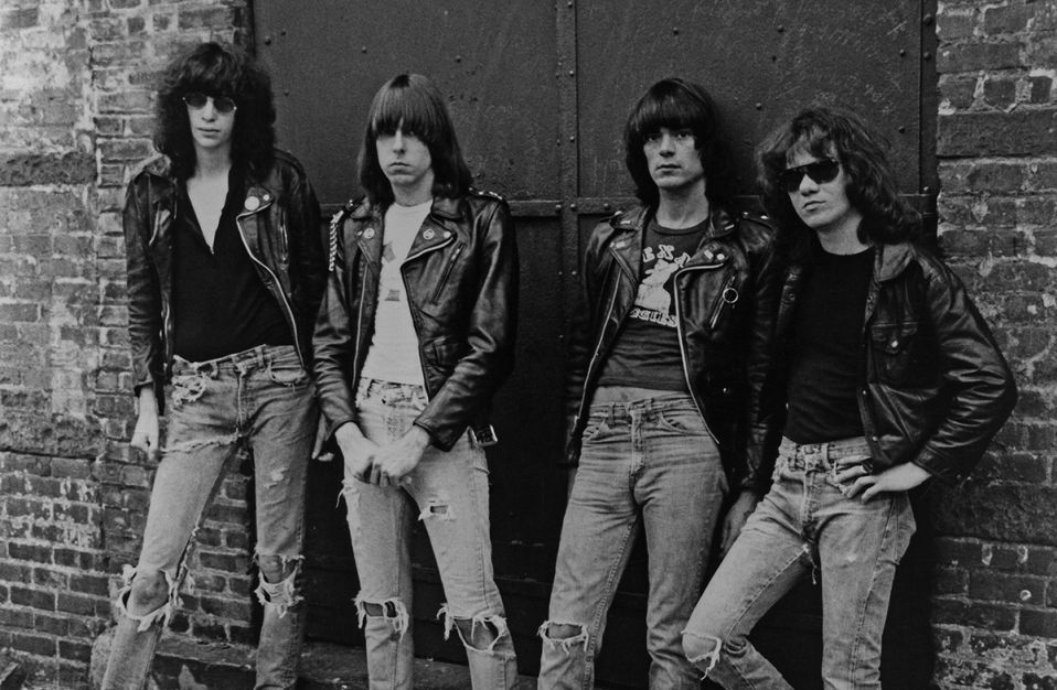 black and white phot of the ramones leaning against brick building