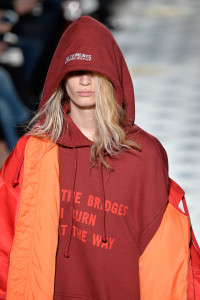 kering fashion show, blone male model wearing oversized jacket and hoodie
