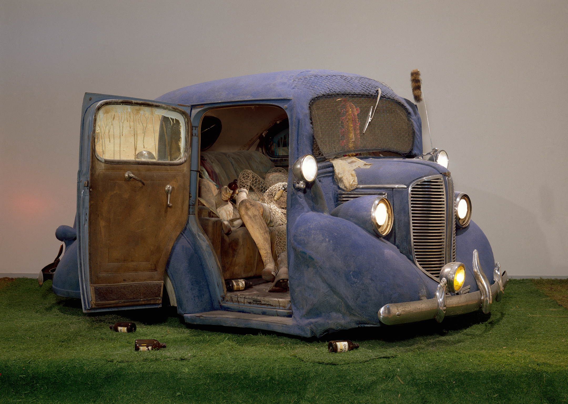 Back Seat Dodge '38 (1964), by Edward Kienholz. Paint, fiberglass and flock, 1938 Dodge, recorded music and player, chicken wire, beer bottles, artificial grass and cast plaster figures, 66 x 120 x 156 inches; installed: 120 x 145 inches. Los Angeles County Museum of Art. © Kienholz. Courtesy of L.A. Louver, Venice, CA. Digital Image © 2016 Museum Associates/LACMA. Licensed by Art Resource, NY.