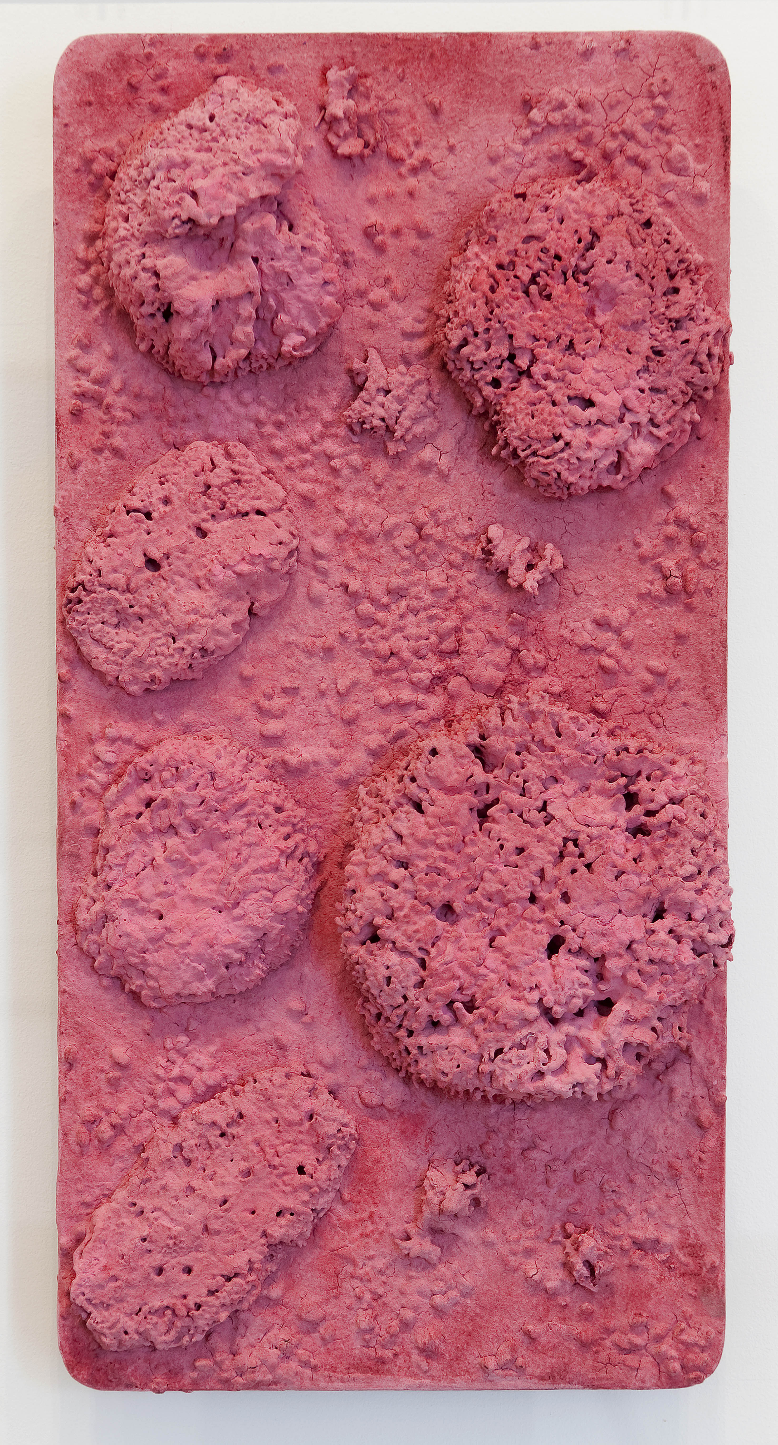 Untitled Pink Sponge Relief (RE 44) (c.1960), by Yves Klein. Dry pigment and synthetic resin, pebbles and natural sponges on panel, 650 x 320 mm. © Yves Klein, ADAGP, Paris / DACS, London, 2016. Carré d’Art-Musée d’art contemporain de Nîmes. Photo David Huguenin.