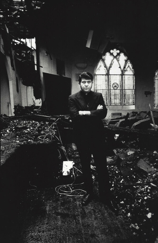 The Reverend Troy Perry, Gay Activist, In His Burnt Down Church, Los Angeles, 1973. Gelatin silver print. 14 x 11”.
