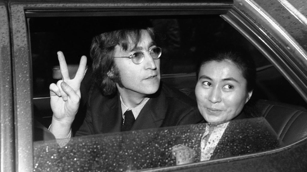 John Lennon Peace sign in car and Yoko Ono