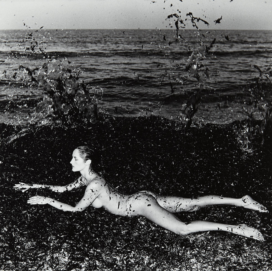 nude woman on beach by Helmut Newton