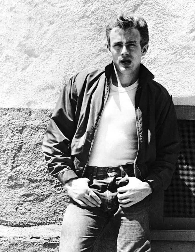 James Dean wearing jeans and a white t-shirt in the film, "Rebel Without A Cause"