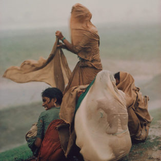 Raghubir Sing photograph of women caught in monsoon rain storm