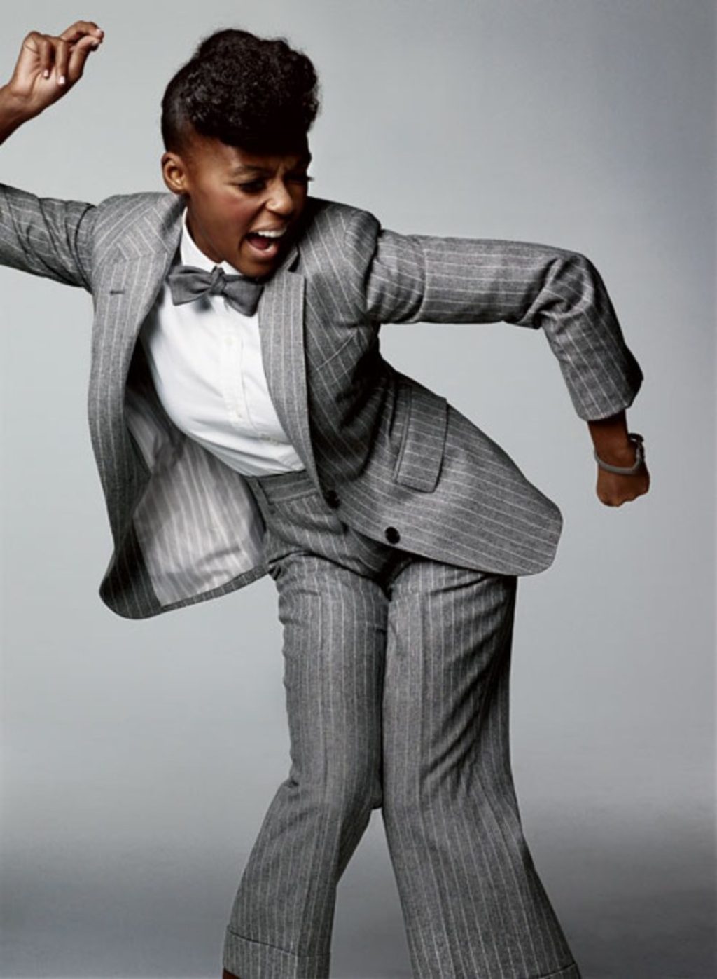 Janelle Monae looking fabulous in a grey pin striped men's suit with grey bow tie