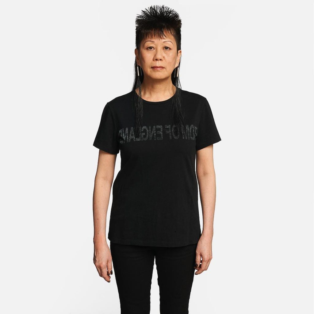 Helmut Lang Native American Model with Spiky Hair Wearing a Black T-Shirt