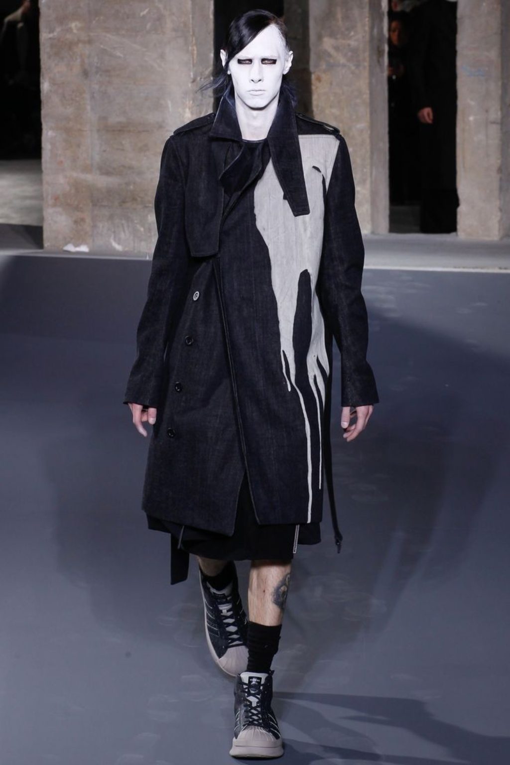 Rick Owens' male model with painted white face and dripping white paint on a black trench coat, Rick Owens Men's Runway, Fall 2017