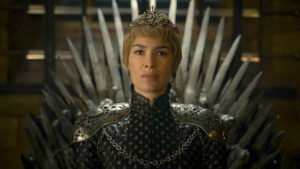 Photo of Lena Headey as Cersei Lannister, the sexiest female villian in HBO Series Game of Thrones- sitting on the throne with short cropped blonde hair wearing a crown.