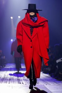 Photo of model in oversized red coat and flamenco black hat from Marc Jacobs Runway Show featuring Marc Jacob's Ready to Wear Collection for Fall/Winter 2018 in NYC