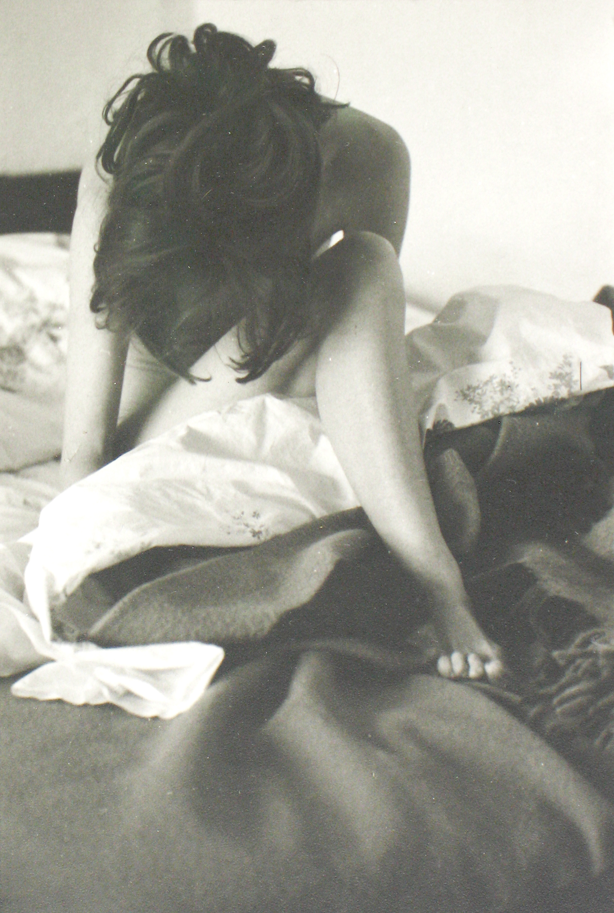 Saul Leiter woman sitting on bed head down