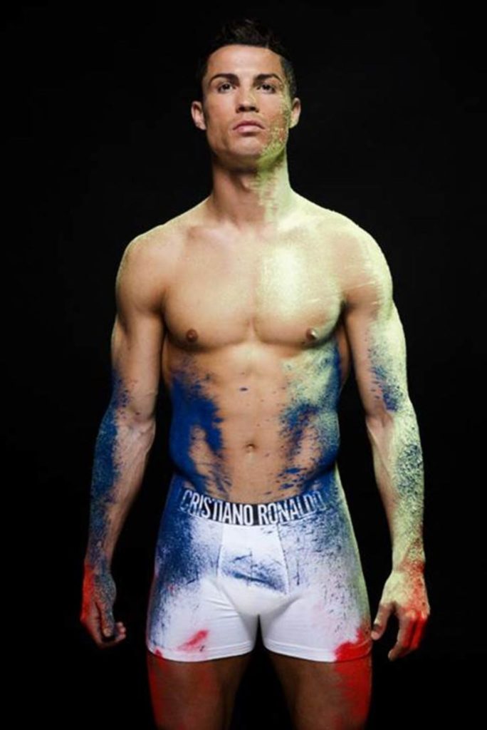 Photograph of Soccer Star Cristiano Ronaldo wearing white tight boxes with spray paint on his undies and body
