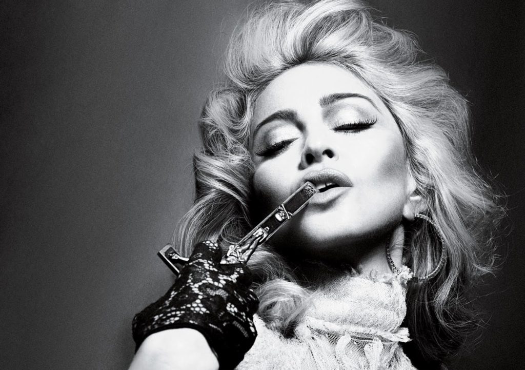 Photograph of Madonna-Interview Magazine-2010-kissing a cross