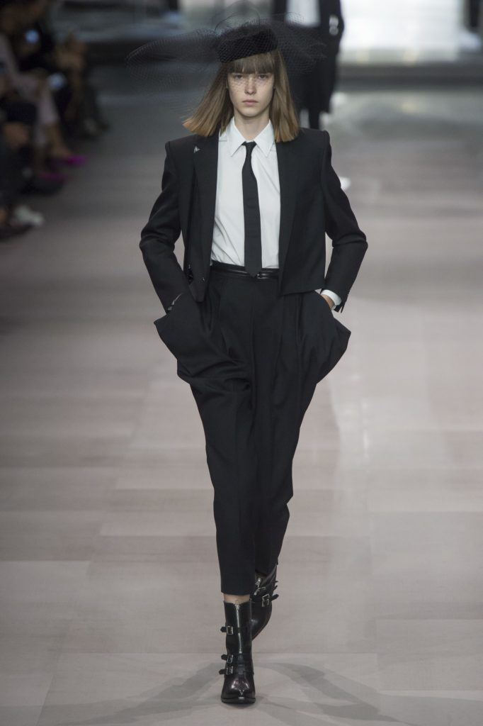 Celine in black suit with skinny black tie