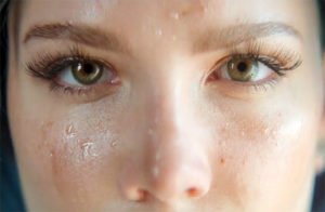close up of Halsey showing her eyes and nose wth sweat on her cheeks