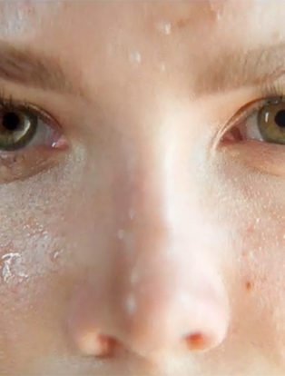 close up of Halsey showing her eyes and nose wth sweat on her cheeks