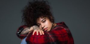 Ella Mai red plaid sitting