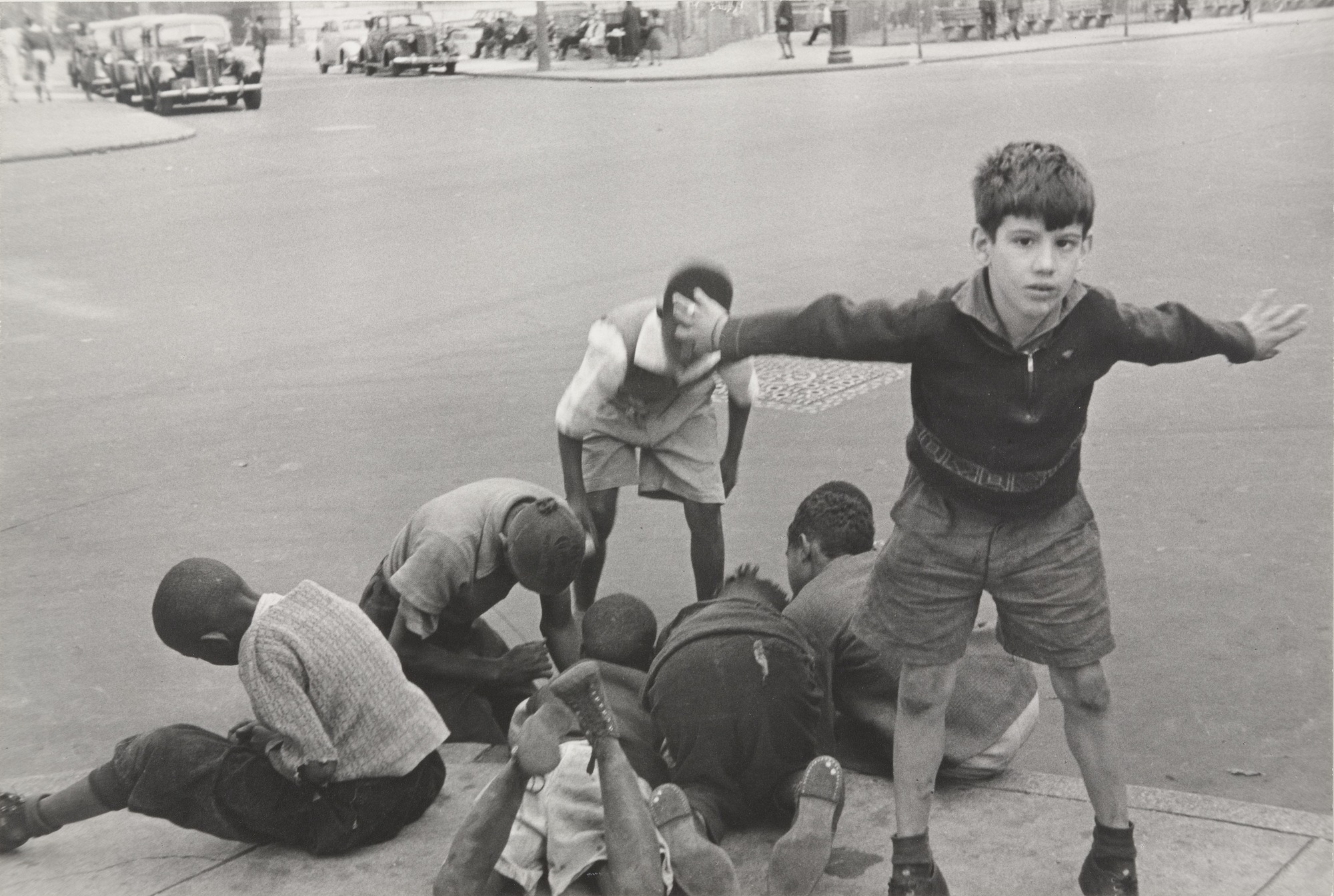 Boys playing on a street corner 