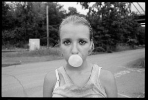 Teen blows bubble with gum