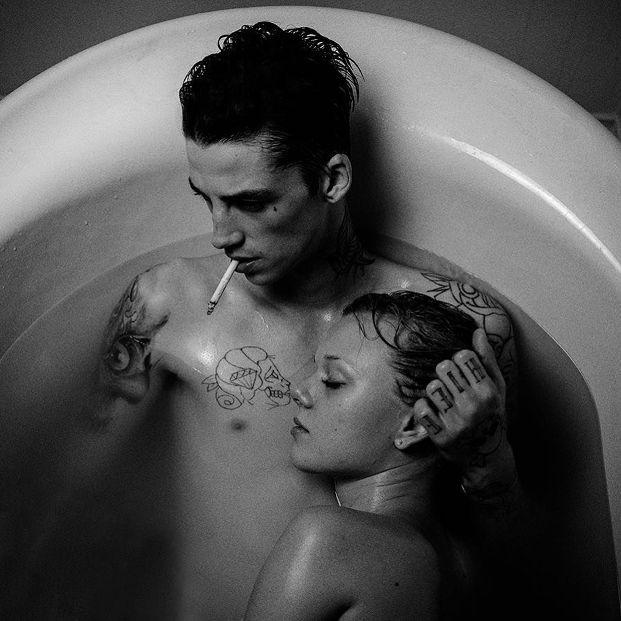 image of a tattooed couple bathing together