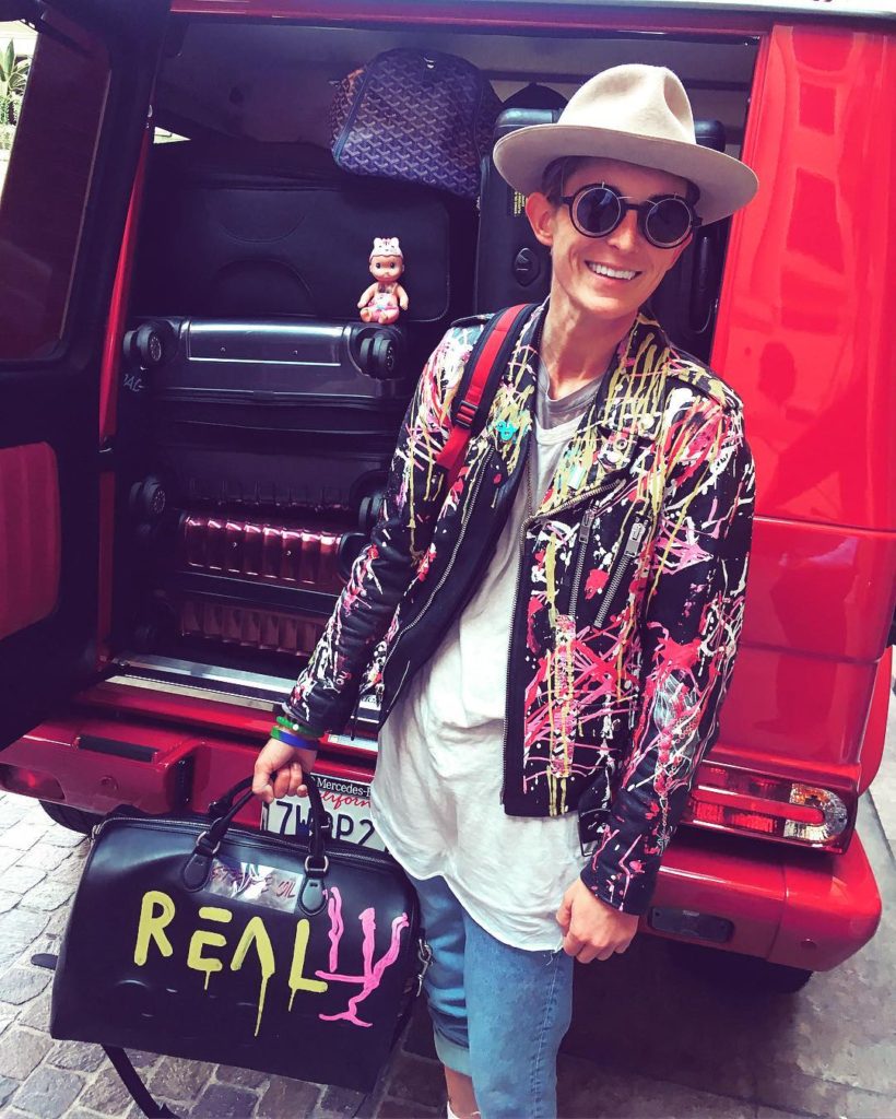 Nats Getty Wearing a Fedora, Her Own Spray Painted Jacket and Carrying a Bag Spray Painted with the word REALLY