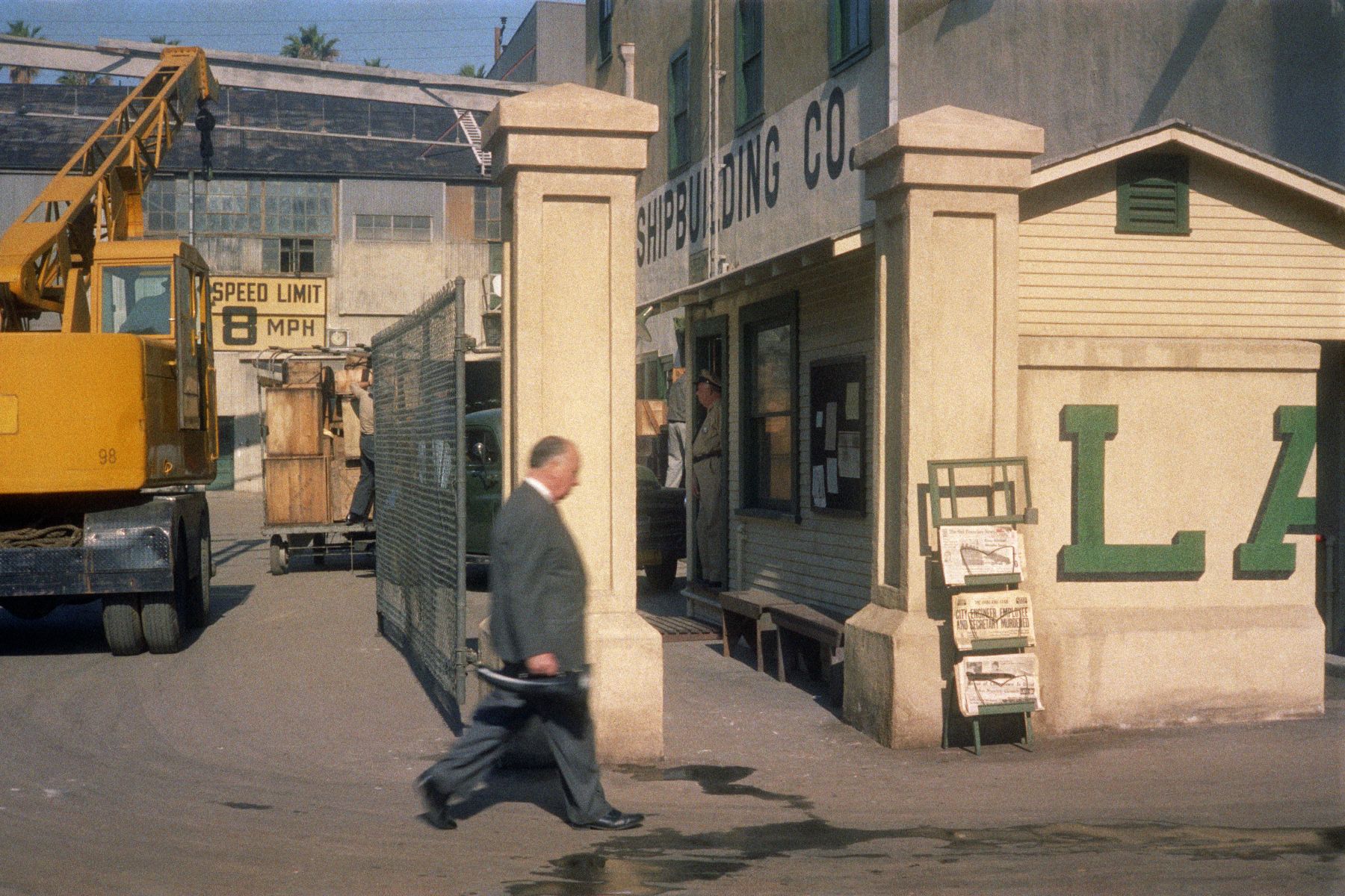 businessman walking past a construction site, vintage
