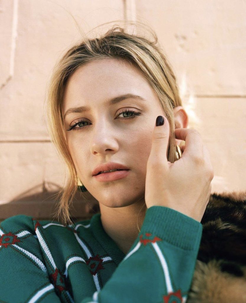 lili-rheinhart-wearing-asos-green-sweater-with-white-strpes and -small-red-and- green-diamond-pattern