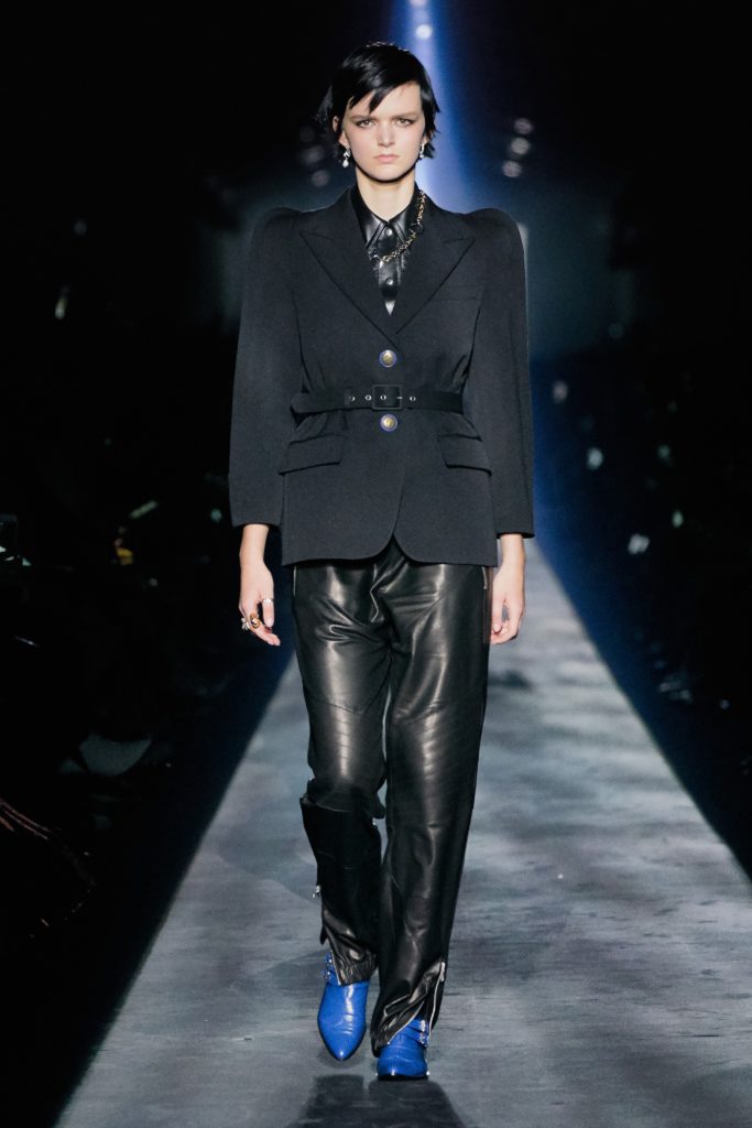 GIVENCHY COLLECTION 2019 RUNWAY SHOW-MODEL WEARING BLACK BLAZER, BLACK LEATHER PANTS AND ROYAL BLUE BOOTS