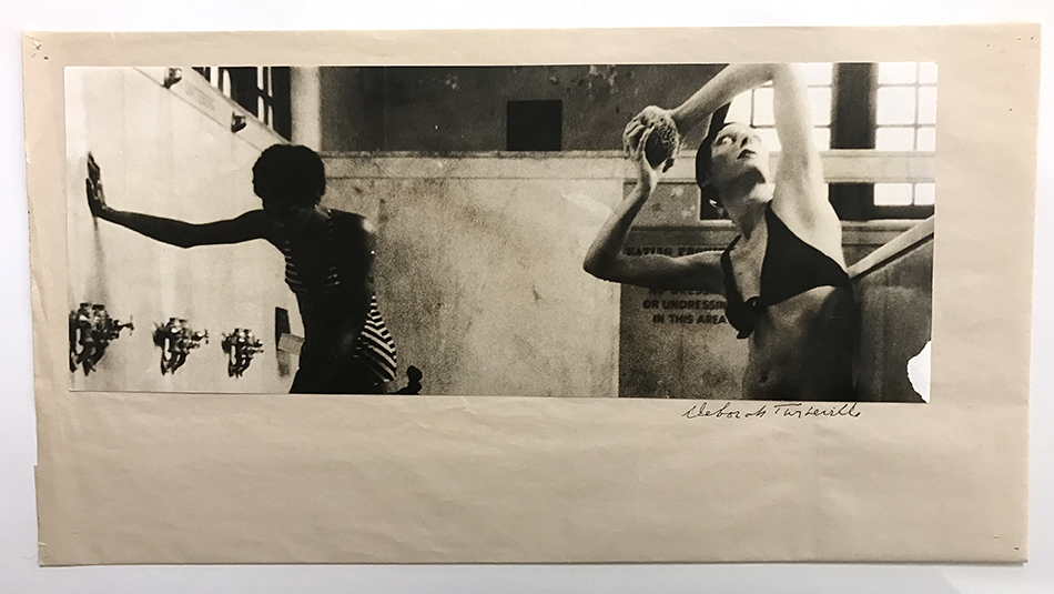 black and white photograph of two women in a bath house