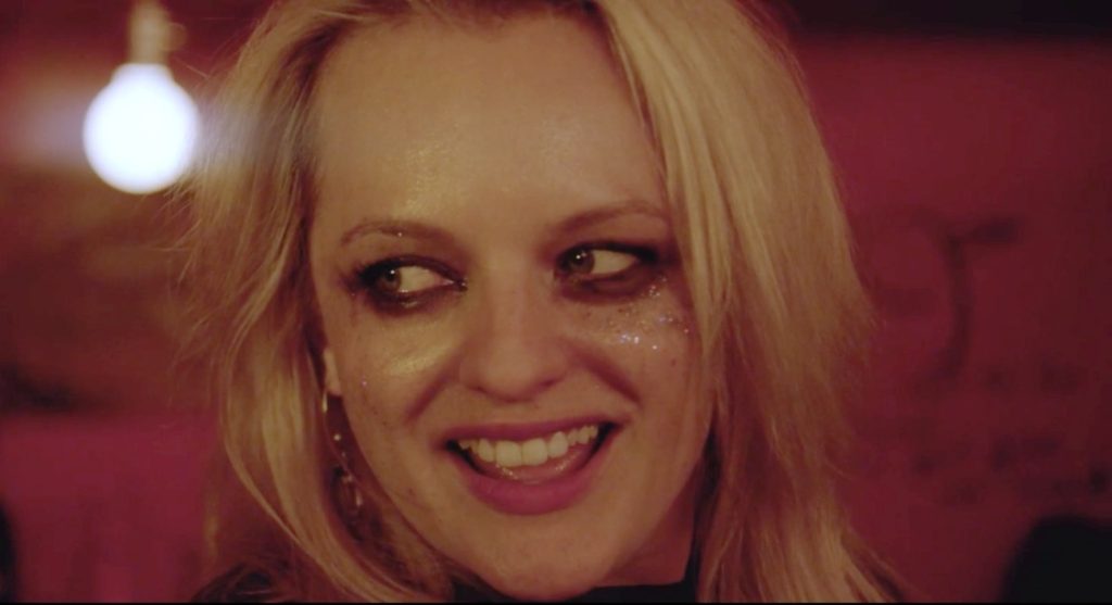 Elizabeth Moss in the rock and roll film her smell wearing runny makeup and sparkles