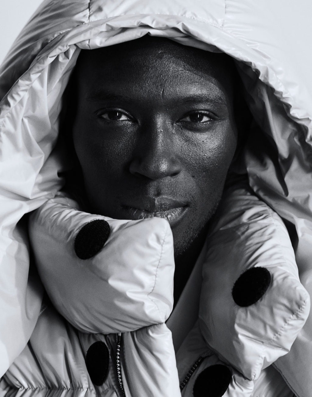Hottest Model ARMANDO CABRAL headshot wearing a hood of an oversized down jacket