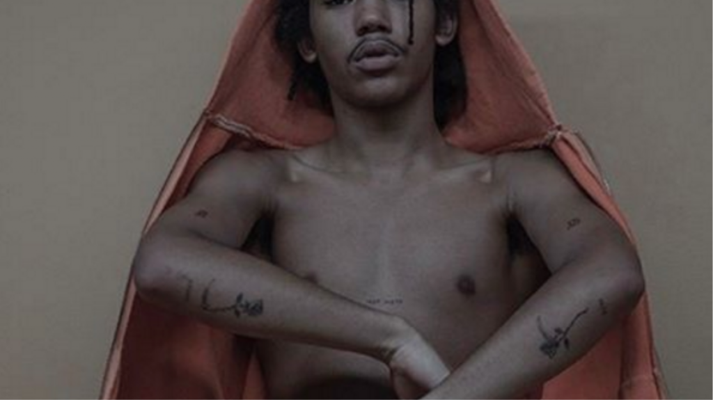 Kayne West Yeezy Zines Young Model Bare Cheasted wearing Orange Hoodie