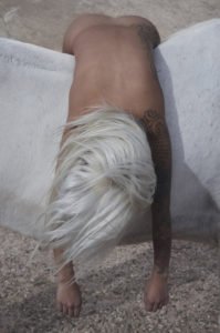 yeezy-zine-image-of-a-naked-body-with-bleach-blond-long-hair-slumped-over-a-white-horse