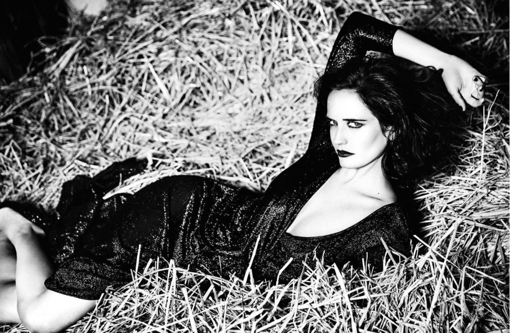 Model in Laying on her side in a field with one arm over her head shot by Ellen Von UnWerth