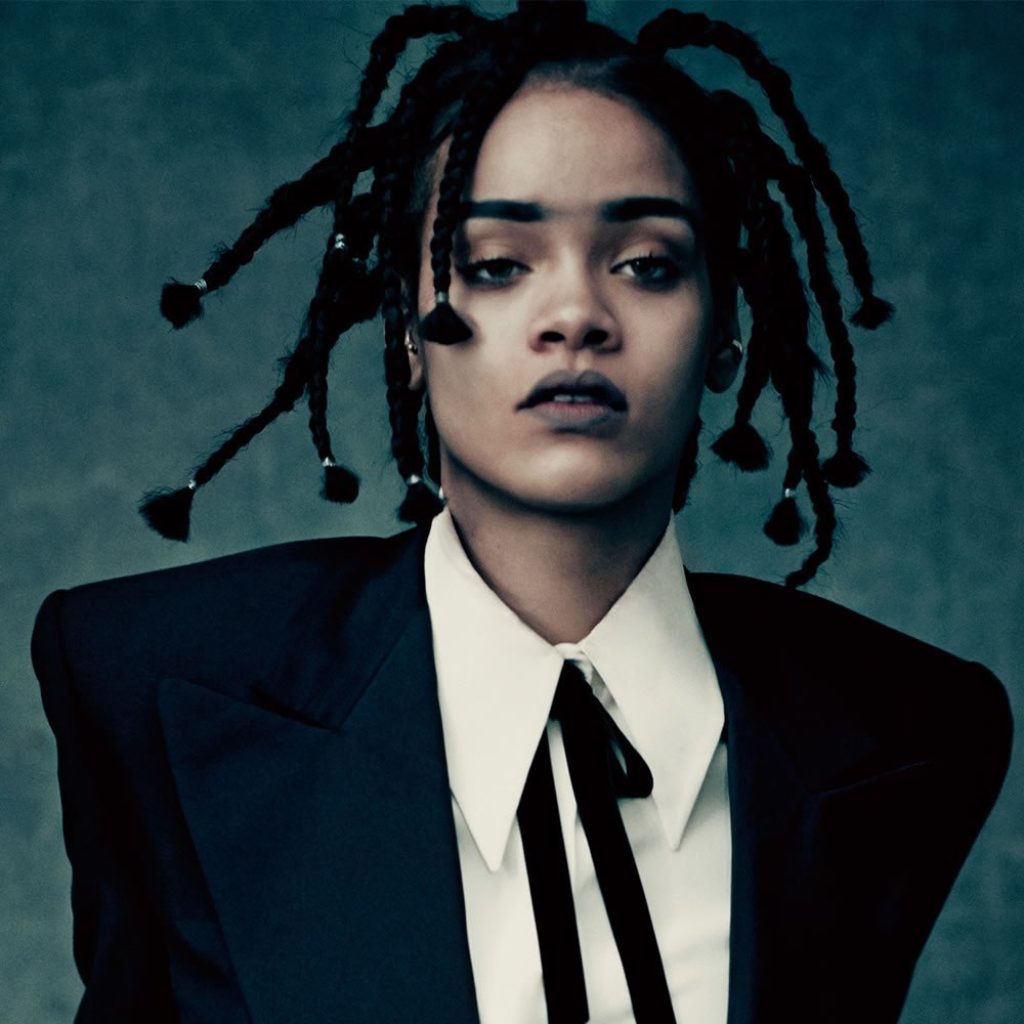 Rhianna wearing dreads and black tuxedo jacket, white shirt and black tie
