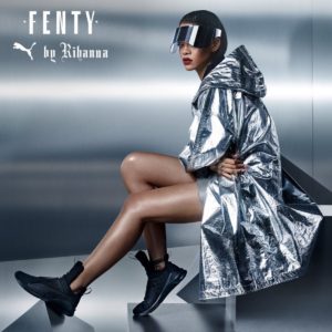 Fenty Rhianna and Puma Collaboration Image of Rhianna wearing black fashion trainers and silver coat