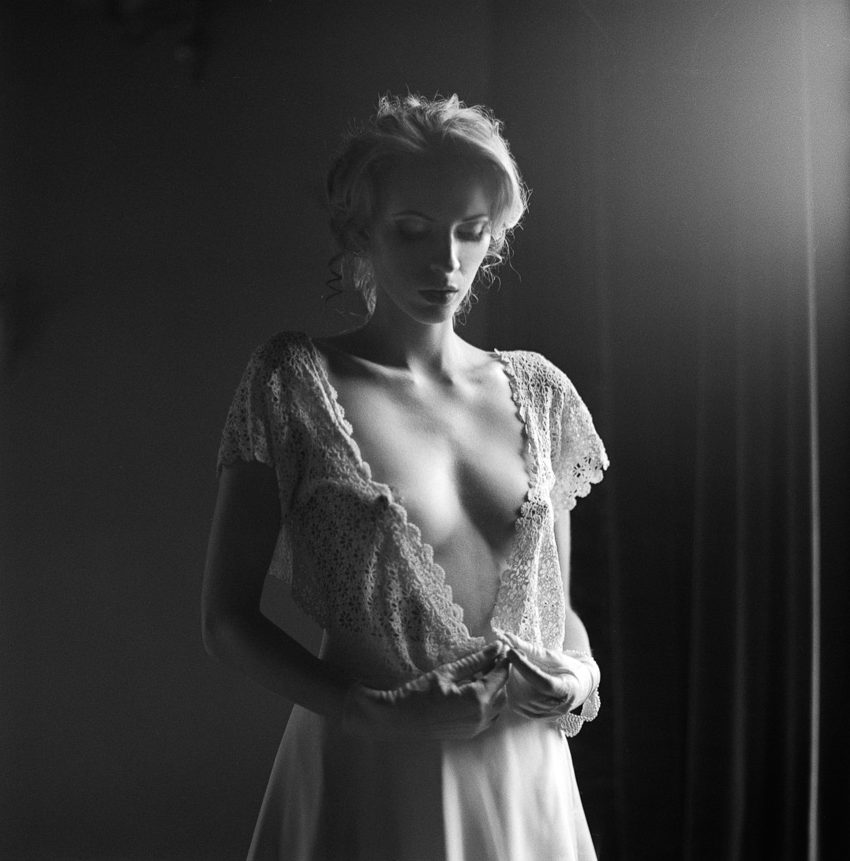 portrait of a young woman in a revealing lace dress