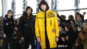 unya-watanabe-north-face collaboration image of a male model wearing a yellow raincoat