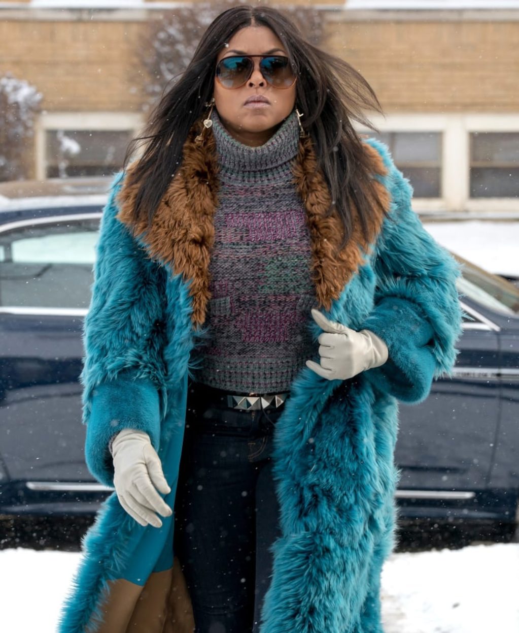 Cookie Lyon in Empire wearing blue and brown fur, grey sweater and white gloves in winter scene